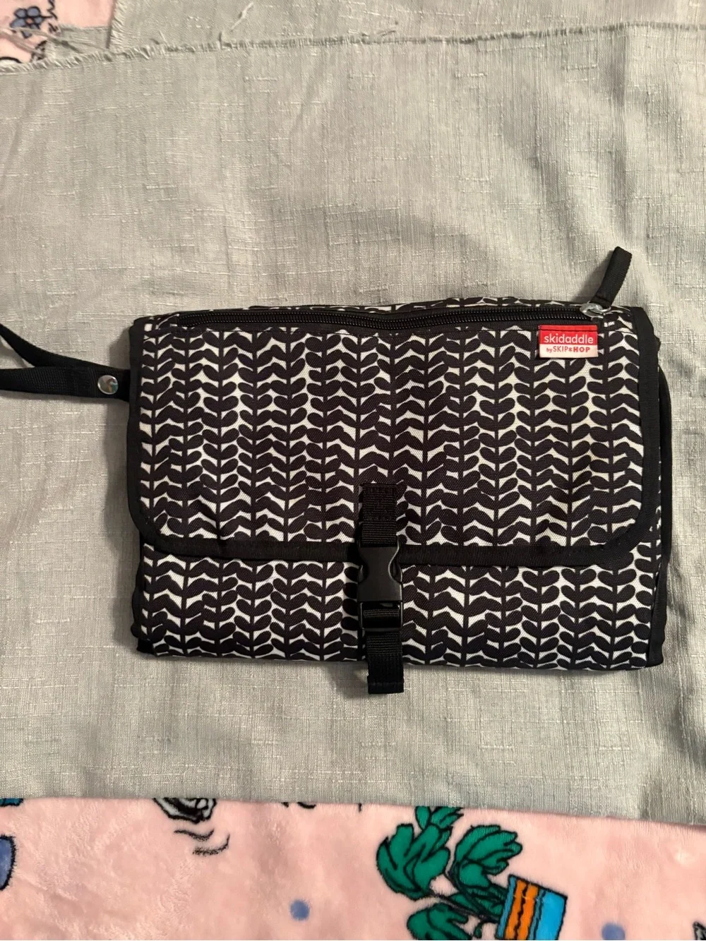 Skidaddle by Skip Hop Black & White Travel diaper bag with fold out changing pad